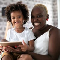 Mother and son playing with digital tablet