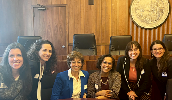 Early Edge Executive Director Patricia Lozano poses with attendees of a legislative briefing.