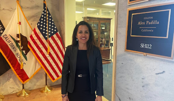 Early Edge executive director Patricia Lozano poses in front of the US and California state flags in Washington D.C.