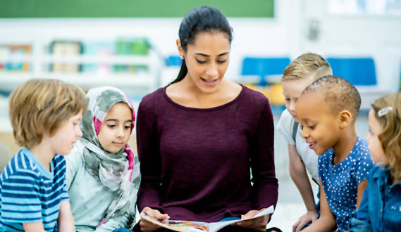 A teacher reads to a diverse group of young children.