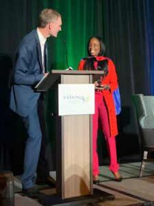 Kidango CEO Scott Moore presented Dr. Burke Harris with a special red cape.