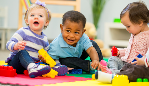 3 babies play together in a daycare.