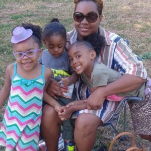 Iesha Nettles sits with her children (l-r) Flowerr, Wyav, and Ahwaze.