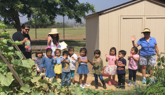 San Diego Unified’s TK 4 stand outside in a garden.
