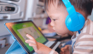 A toddler plays a learning game on a tablet.