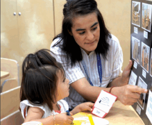 A provider is matching labels with a preschool age student.