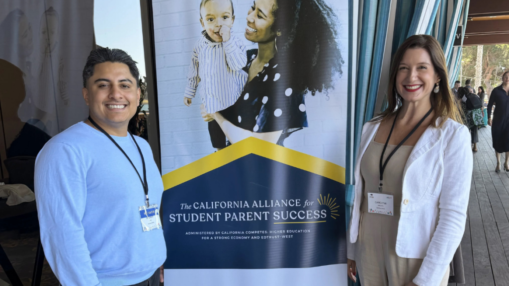 Policy Corner Andrew and Carolyne pose in front of a banner at the 2026 California Alliance for Student Parent Success