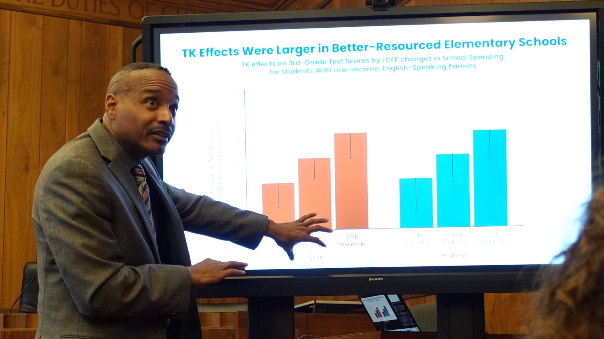 A presenter shares information from a slide at TK Payoff Meeting in Sacramento